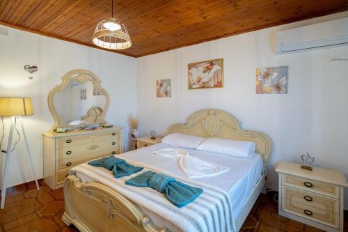 a bedroom with a bed and a dresser and a mirror at Villa Balani in Široka