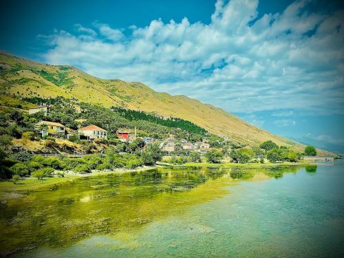 a town on a hill next to a body of water at Villa Balani in Široka