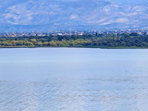 a large body of water with a city in the background at Villa Balani in Široka