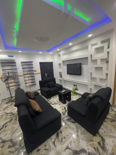 a living room with two couches and a flat screen tv at Royal Homes Shortlet Apartment 