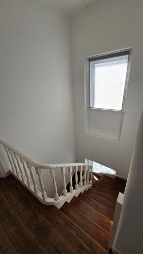a white room with a window and a crib at SAN PEDRO Beach House in Estoril