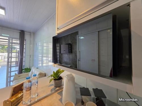 a living room with a large television on the wall at Casa com 2 quartos na Vila A prox Paraguai e Itaip in Foz do Iguaçu