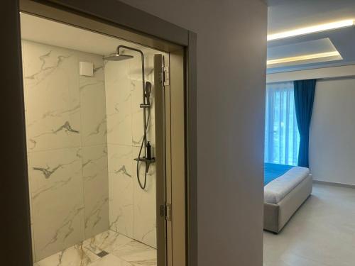 a bathroom with a shower with a glass door at Hotel 6 Marsi in Golem