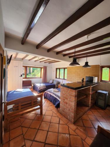 a living room with a couch and a fireplace at Hotel Ficus Villa de Leyva in Villa de Leyva