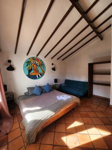 a bedroom with a large bed in a room at Hotel Ficus Villa de Leyva in Villa de Leyva