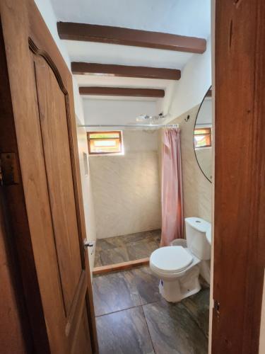 a bathroom with a toilet and a ceiling at Hotel Ficus Villa de Leyva in Villa de Leyva