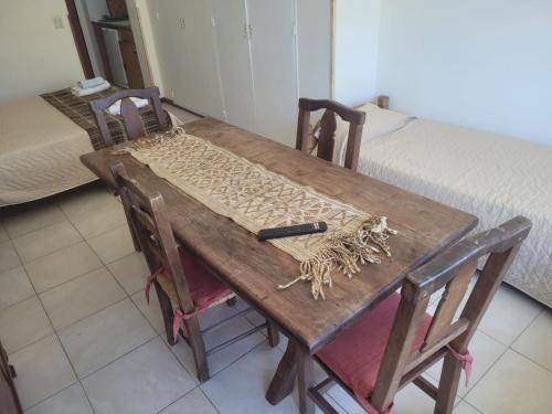 a wooden table with a cutting board on it at Centro Bariloche Apart in San Carlos de Bariloche
