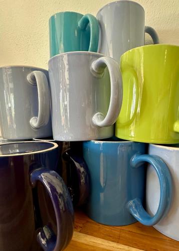 a pile of coffee mugs stacked on top of each other at Nereus in Puerto Jiménez
