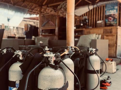 a group of gas cylinders lined up in a room at Rising Sun Bungalows in Gili Meno
