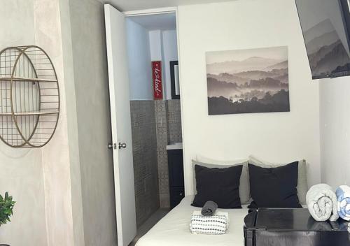 a room with a bed and a door with a picture at The Pelican Poshtel in San Juan