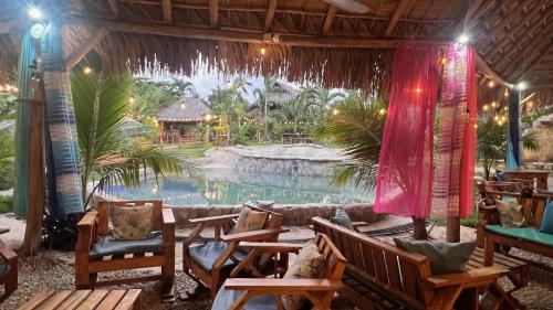 a resort with a large swimming pool in the background at CHALET TROPICAL Hotel & Restaurant-Pizzeria in Las Galeras