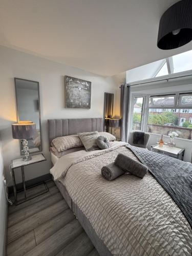 a bedroom with a bed with two pillows on it at Stunning 1 BR Studio - NEC, BHX, HS2, JLR - Free Netflix in Marston Green