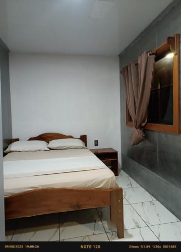 a bedroom with a bed and a window at Coconut Lodge #2 in Pavones