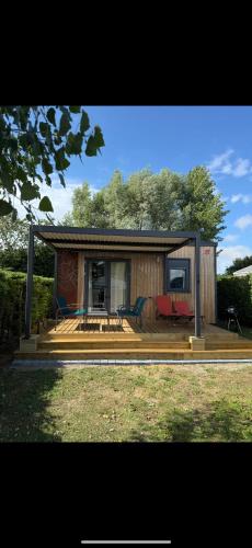 a small house with a porch and a deck at Chalet Rapidhome in Ambleteuse