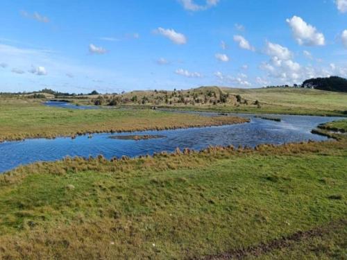 a river in the middle of a field at 4 person holiday home in Hals-By Traum in Hals