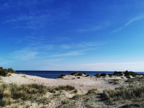a sandy beach with the ocean in the background at 8 person holiday home in Melby in Melby