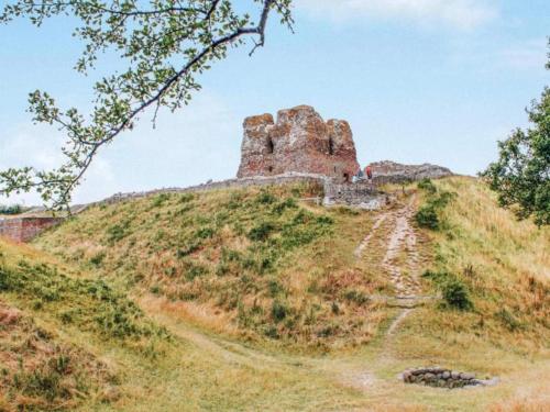 a castle on top of a grassy hill at 6 person holiday home in Kolind-By Traum in Kolind