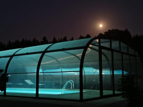 a building with a swimming pool at night at Quinta da Poipa in Celorico da Beira