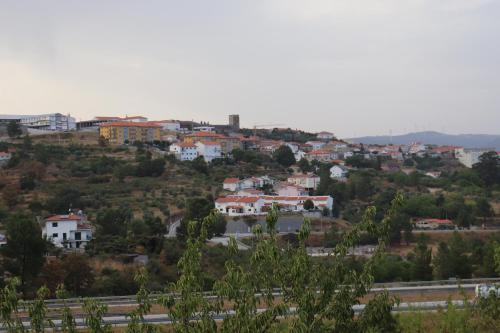 a town on top of a hill with a highway at Quinta da Poipa in Celorico da Beira