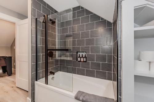 a bathroom with a shower and a bath tub at Cozy Retreat W Hot Tub Bruce Peninsula in Stokes Bay
