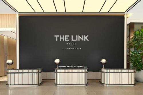 a lobby with a black wall with the link sign at The Link Seoul, a Tribute Portfolio Hotel in Seoul