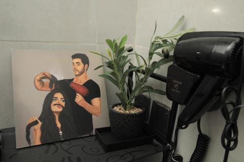 a painting of a man cutting a womans hair at The District in Jeddah