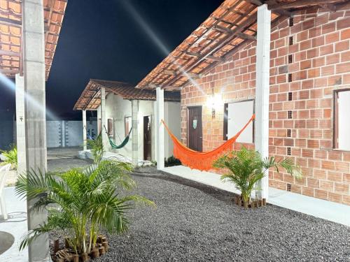a building with an orange hammock outside of it at Canto das Praieiras - Porto de Sauípe, Rio & Mar in Porto de Sauipe