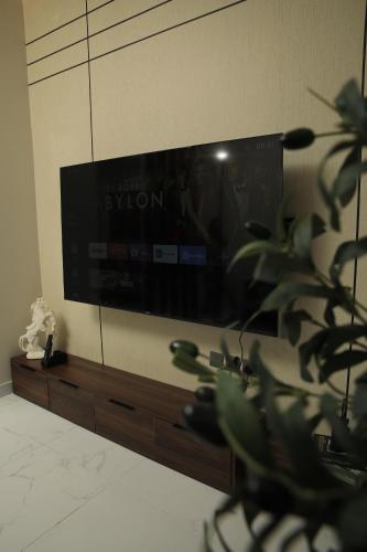 a flat screen tv on a wall in a living room at The District in Jeddah