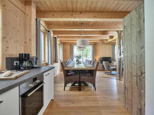 a kitchen and dining room with a table and chairs at Mur-Chalet St Michael L in Sankt Michael im Lungau