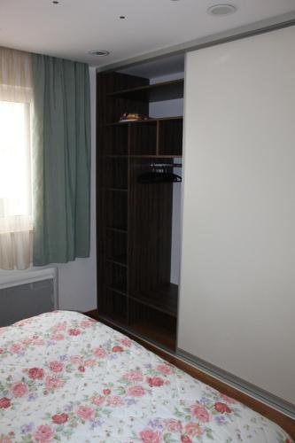 a bedroom with a bed and a book shelf at Apartment Patricia in Vodice