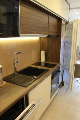 a kitchen with a sink and a microwave at Apartment Patricia in Vodice