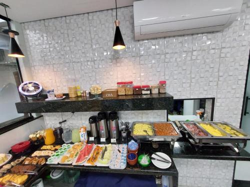 a buffet line with many different types of food at Pousada Nossa Senhora de Copacabana in Aparecida