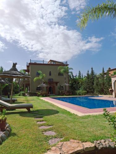 a villa with a swimming pool and a house at Villa Hamza Marrakech in Bou Touil