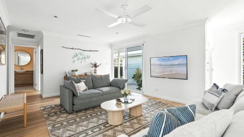 a living room with a couch and a table at The Salty Perch in Callala Beach