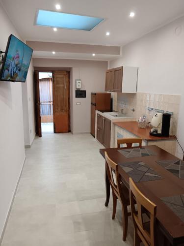 a kitchen and dining room with a table and chairs at Gioia in Calitri