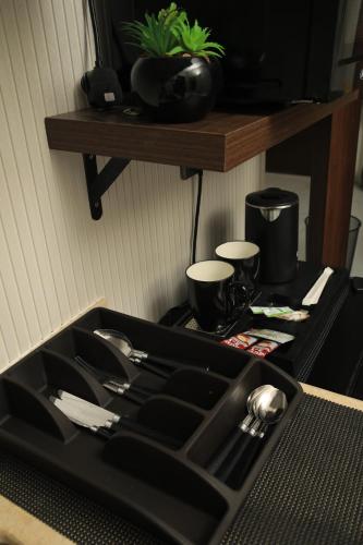 a black tray with silver utensils on a table at The District in Jeddah