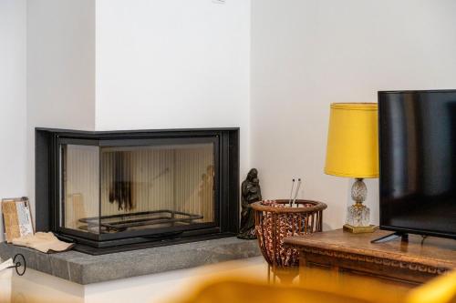 a living room with a fireplace and a tv at Italian Experience- Poggio Padule in San Venanzo