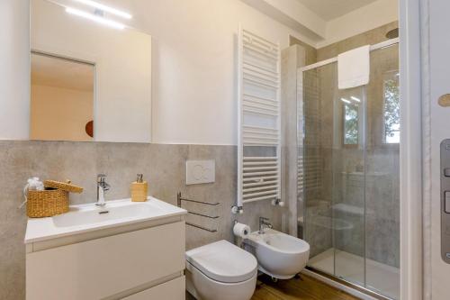 a bathroom with a toilet and a sink and a shower at Italian Experience- Poggio Padule in San Venanzo