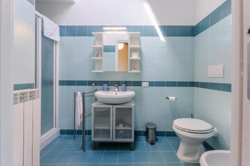 a blue bathroom with a sink and a toilet at Italian Experience- Poggio Padule in San Venanzo