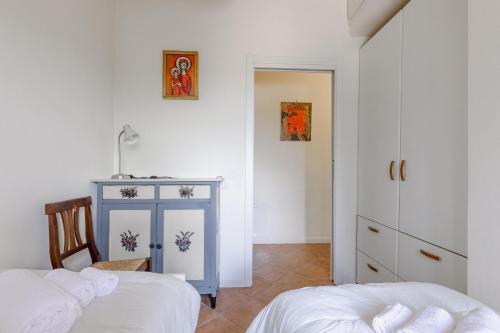 a bedroom with two beds and a blue cabinet at Italian Experience- Poggio Padule in San Venanzo