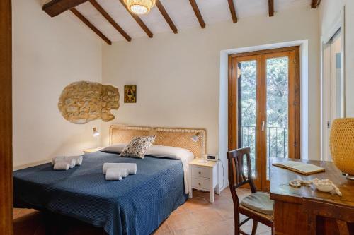 a bedroom with a bed with two towels on it at Italian Experience- Poggio Padule in San Venanzo