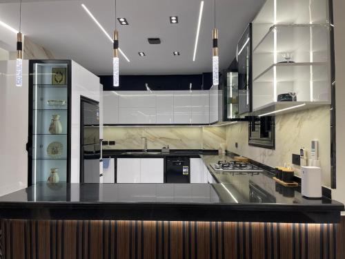 a large kitchen with a black counter top at Brand New Apartment Obour City in Obour