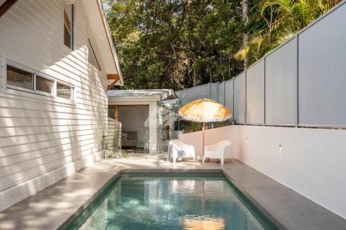 a swimming pool in the backyard of a house at Blackbutt House - Luxe Retreat With Pool and Sauna in Suffolk Park