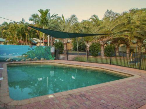 a swimming pool in a yard with a fence at 1770 Beachside Backpacker in Agnes Water
