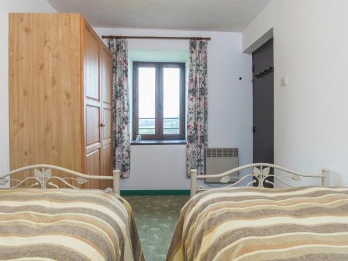 a bedroom with two beds and a window at Normandy Countryside Stay in Montaigu-les-Bois