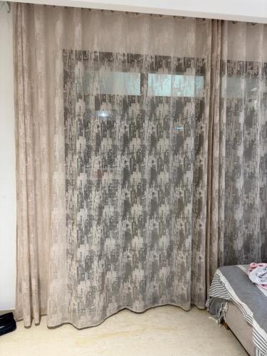 a bedroom with a window with a curtain at Lynda in Nabeul