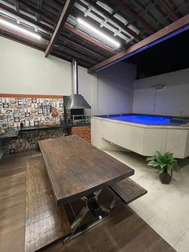 a room with a table and a bath tub at House in Condominium with Pool 20 min from COP30 in Ananindeua