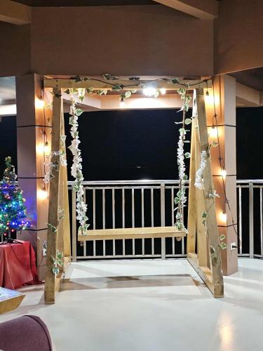 a room with a stage with a christmas tree and lights at Eagles Nest Beach Resort in Davao City