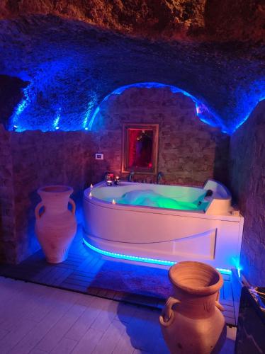 a bathroom with a bath tub with blue lights at La grotta romantica in Fabrica di Roma