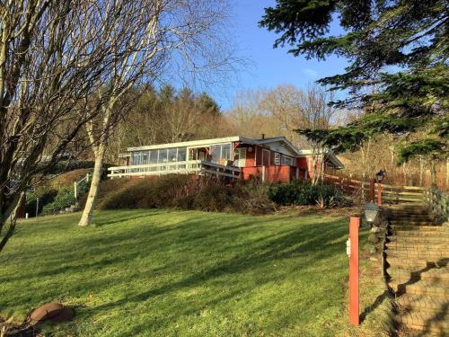 a house sitting on top of a lush green field at 6 person holiday home in Struer-By Traum in Struer